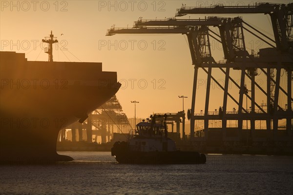 Tugboat and container ship of port of Oakland