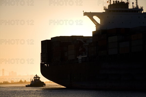 Tugboat and container ship in port of Oakland