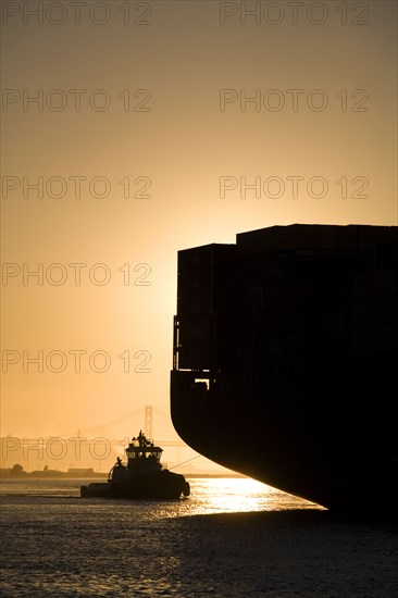 Tugboat and container ship in port of Oakland