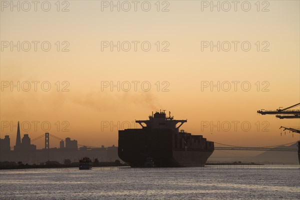Tugboat and container ship in port of Oakland