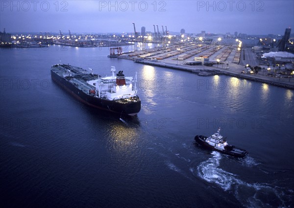 Tugboat and container ship in the port of Long Beach