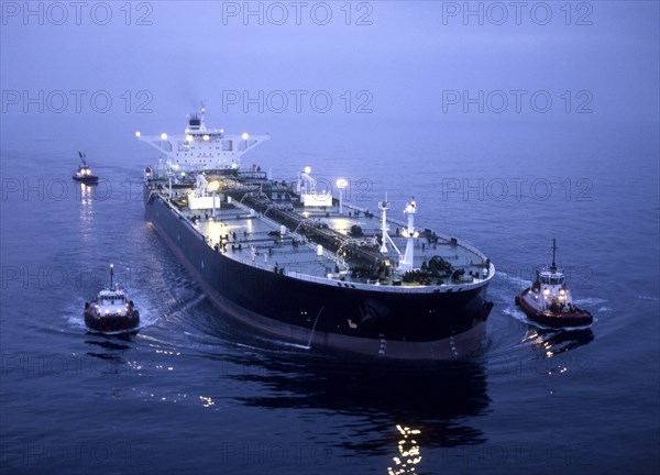 Tugboats and container ship in the port of Long Beach