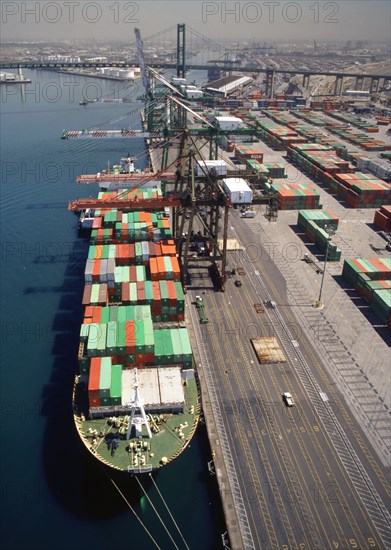 Cranes over container ship at commercial dock