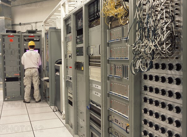 Computer programmer working in server room