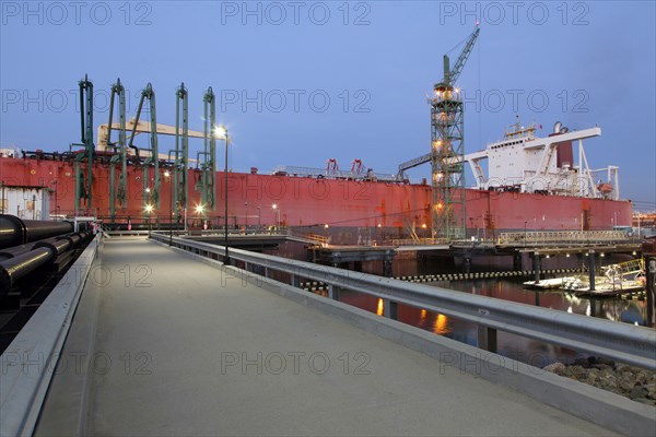 Concrete walkway to container ship in shipyard