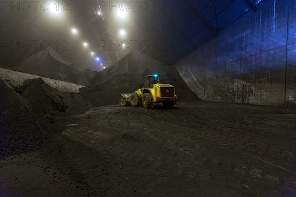 Digger working in warehouse