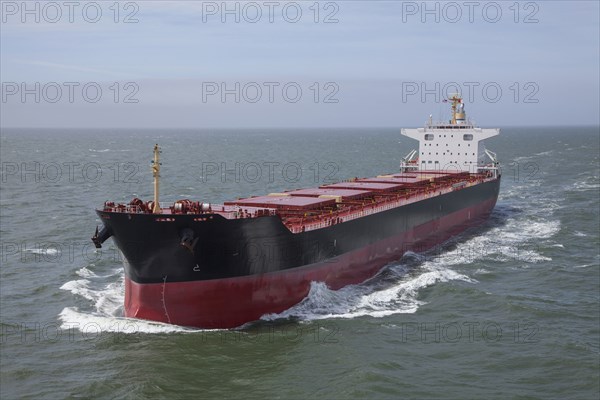 Container ship sailing on calm sea