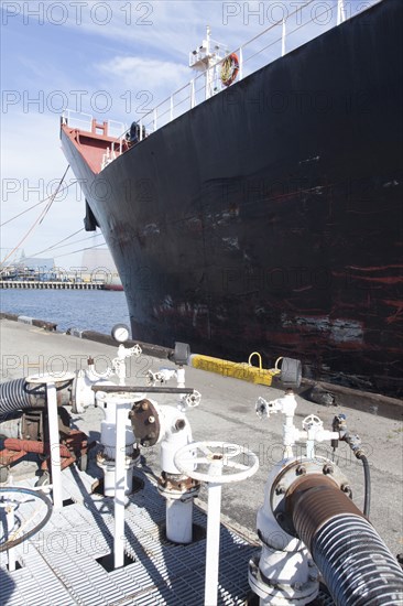 Oil tanker ship docked in industrial harbor