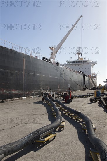 Oil tanker ship docked in industrial harbor