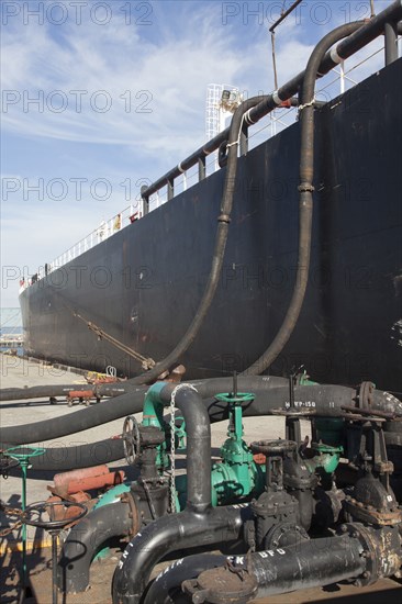 Oil tanker ship docked in industrial harbor