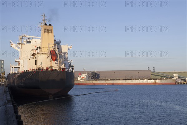 Oil tanker ship docked in industrial harbor