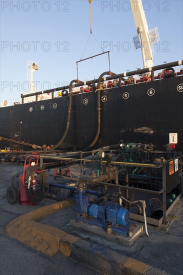 Oil tanker ship docked in industrial harbor