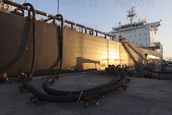 Oil tanker ship docked in industrial harbor