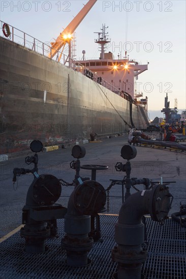 Oil tanker ship docked in industrial harbor