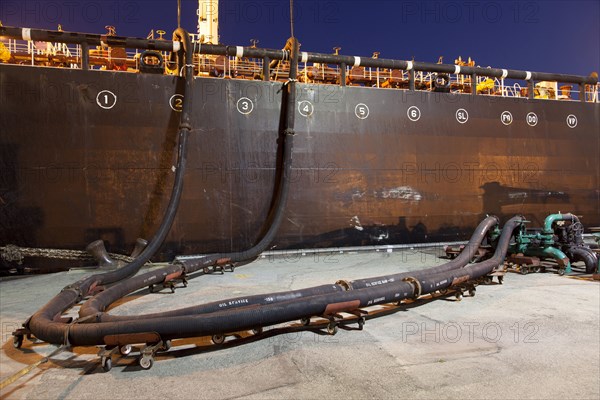 Oil tanker ship docked in industrial harbor