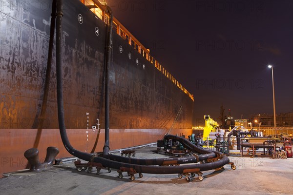 Oil tanker ship docked in industrial harbor