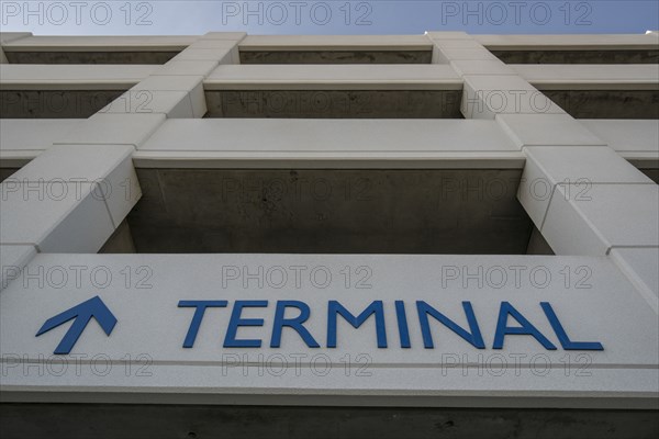 Arrow and terminal sign on parking garage
