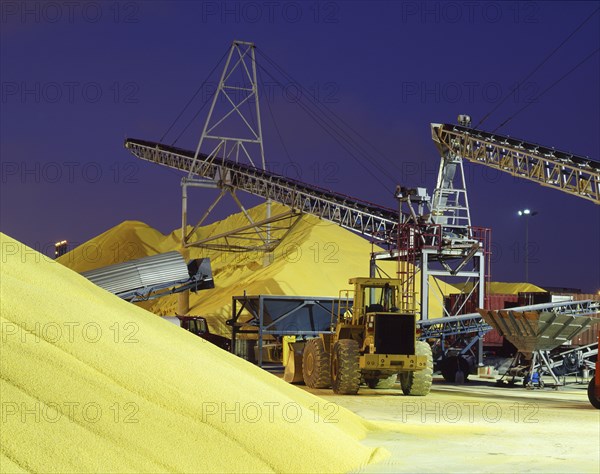 Bulldozer near piles of grain