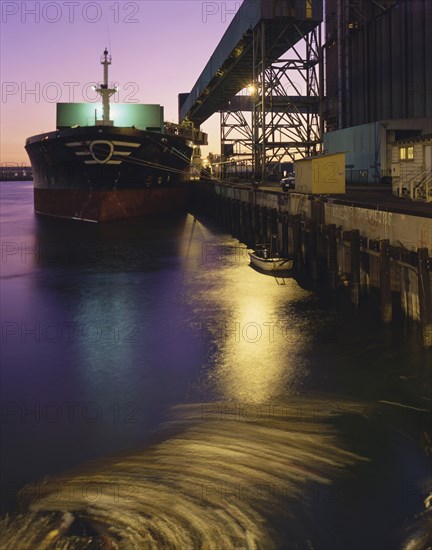 Cargo ship in harbor at night