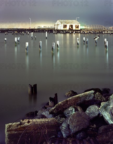 Pillars in still water at night