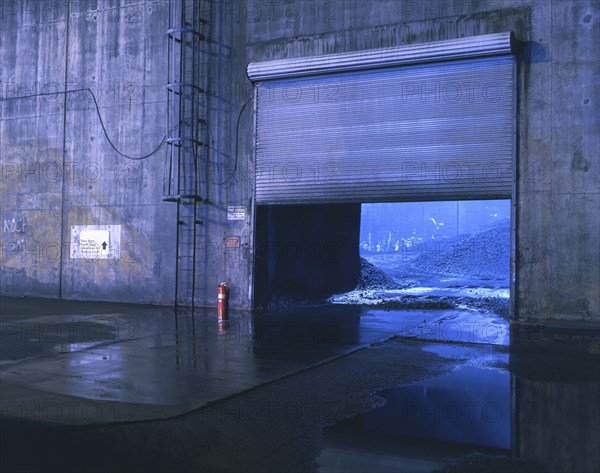 Garage door near puddles at night