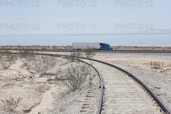 Semi-trick driving near railroad track