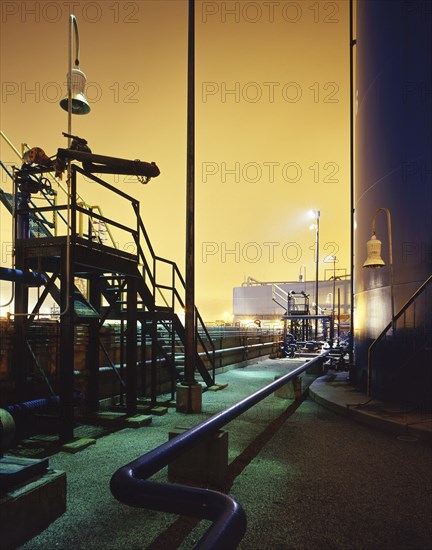 Blue industrial pipes and storage tank