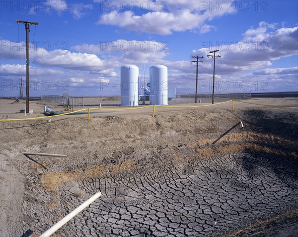 Dry drainage ditch near silos