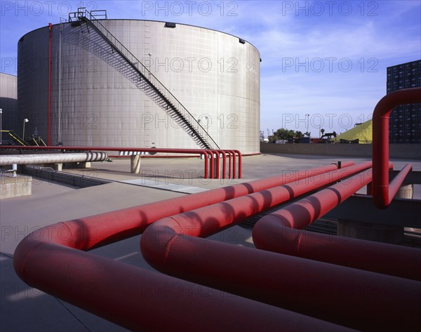 Red pipes near storage tank