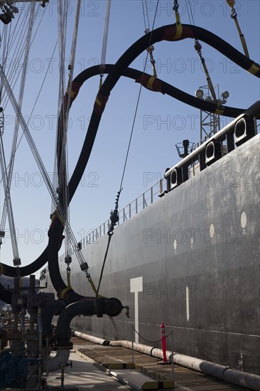 Pipes connecting hoses to freighter at port