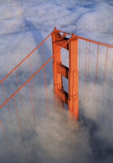 Aerial view of orange bridge over fog