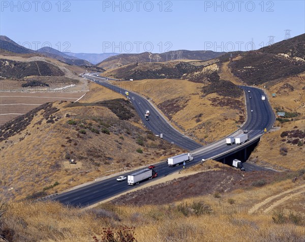 Trucks and cars driving on freeway overpass