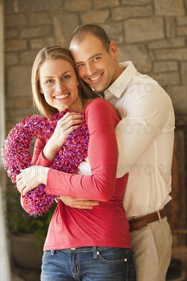 Caucasian couple holding heart