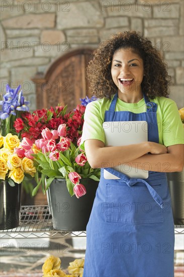 Mixed race florist holding digital tablet