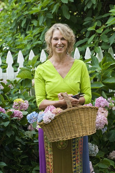 Caucasian woman gathering flowers