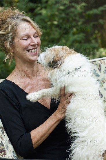 Caucasian woman playing with dog