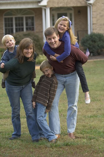 Family playing together on front lawn