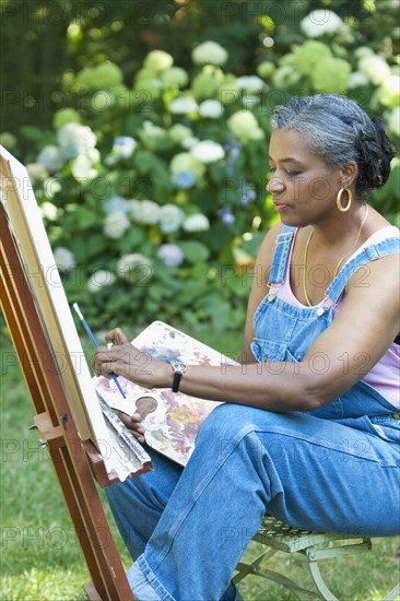 Black artist painting outdoors