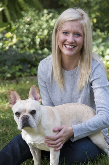 Caucasian woman petting dog outdoors