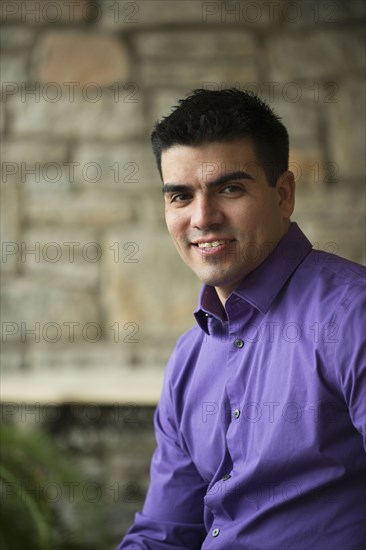 Hispanic businessman sitting indoors