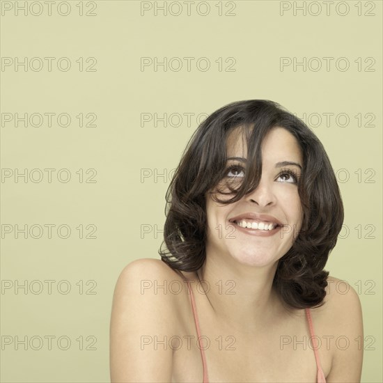 Studio shot of young Hispanic woman smiling