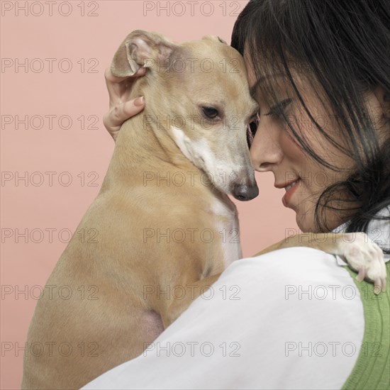 Studio shot of young woman and dog
