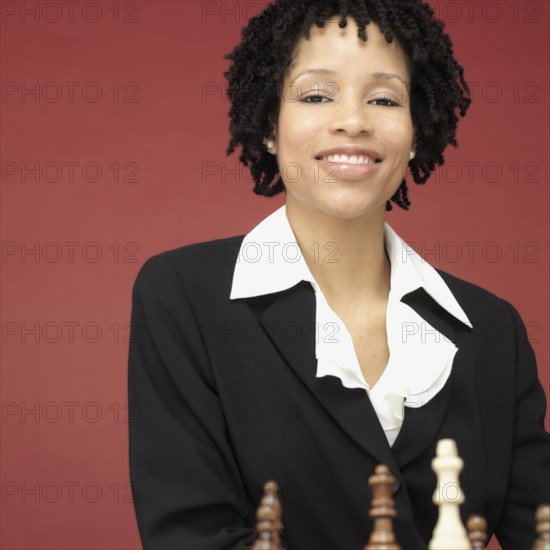 Studio shot of African woman playing chess