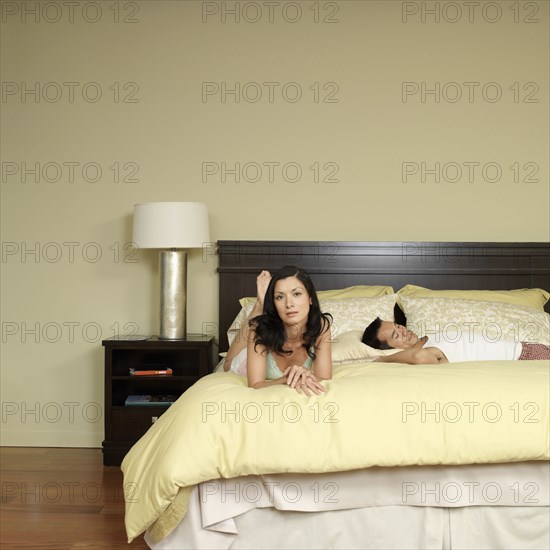 Asian couple laying on bed