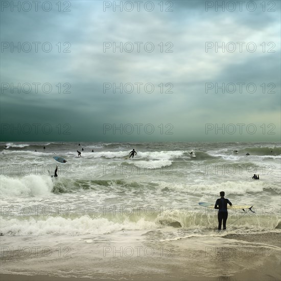 People surfing in stormy ocean