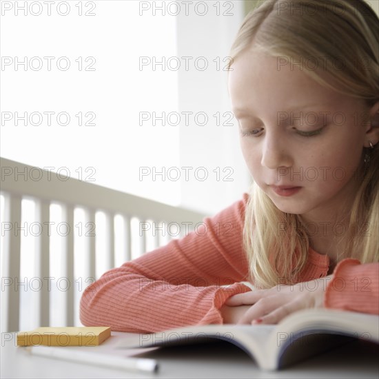 Caucasian girl reading book