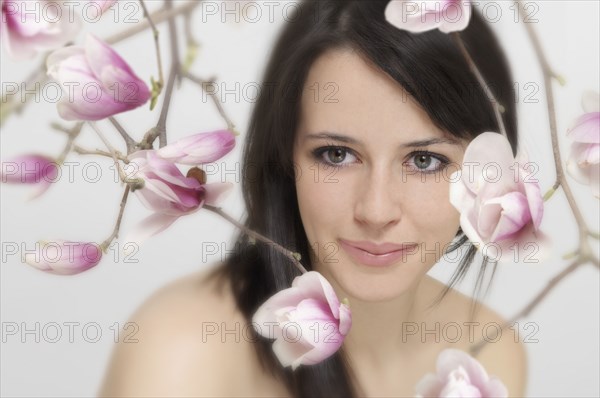 Mixed race woman with flowers in foreground