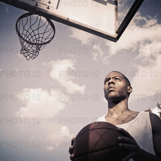 African American man playing basketball on court