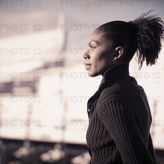 African American woman walking by bleachers