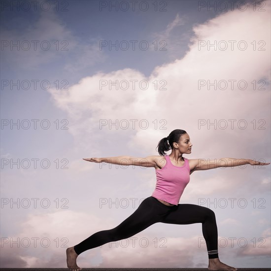 African American woman practicing yoga outdoors